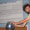 Chris McCarthy touching a van de graaff generator with big fuzzy hair