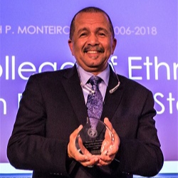 Kenneth Monteiro with award, headshot
