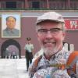 Edward J Carpenter standing in front of the Forbidden City