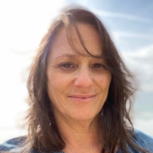 Karen Crow head shot showing sky and sun